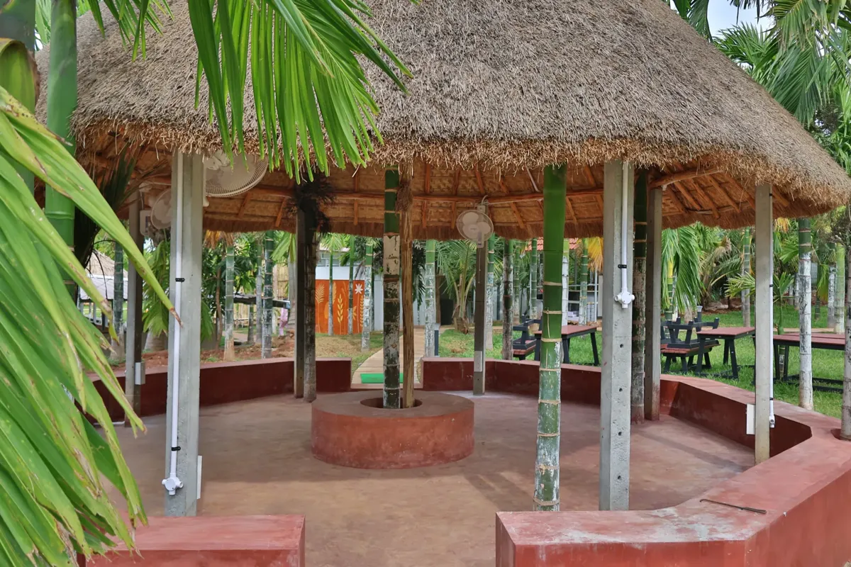 Thatched gazebo with round seating in the garden at Arekas Bamboo Arcadia near Yelahanka, Bangalore